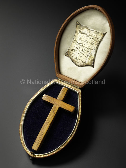 Commemorative Cross in Presentation Box, Made from the Wood of the Mvula Tree under which David Livingstone's Heart was Buried after his Death in May 1873, [c.1900]. Image copyright National Museums Scotland. Used by permission. Any form of reproduction, transmission, performance, display, rental, lending, or storage in any retrieval system without the written consent of the copyright holders is prohibited. Downloading the images for use by third parties and end users is strictly prohibited, except for private study. Downloading of images for commercial purposes will be treated as a serious breach of copyright and strong legal action will be taken by National Museums Scotland.