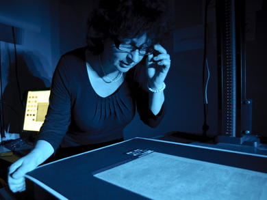 Debbie Harrison examines a page of Livingstone's 1871 Field Diary, National Library of Scotland, 2010. Copyright Callum Bennetts - Maverick Photo Agency. Used by permission.