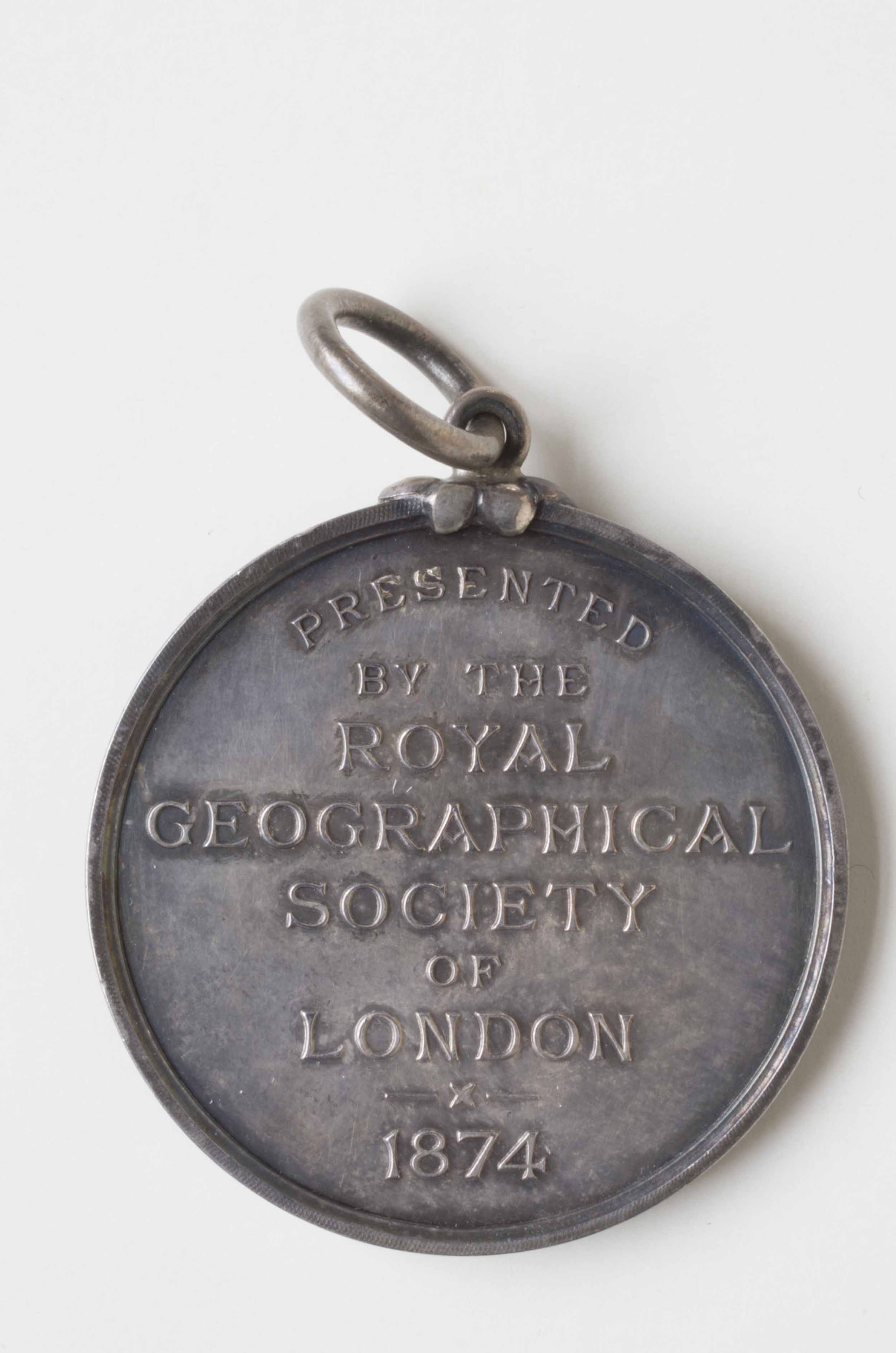 Royal Geographical Society silver medal, awarded retrospectively to each of the Africans who carried David Livingstone's body to the East Coast of Africa. Copyright David Livingstone Centre. Object images used by permission. May not be reproduced without the express written consent of the National Trust for Scotland, on behalf of the Scottish National Memorial to David Livingstone Trust. Images of the objects from the David Livingstone Centre are copyright Roddy Simpson. Creative Commons Attribution-NonCommercial 3.0 Unported (https://creativecommons.org/licenses/by-nc/3.0/).